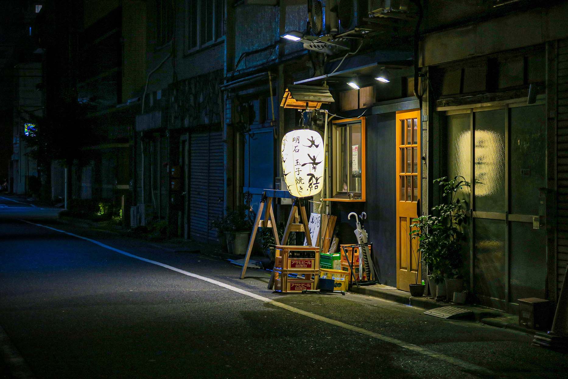 A restaurant entrance on a quiet street in Osaka.